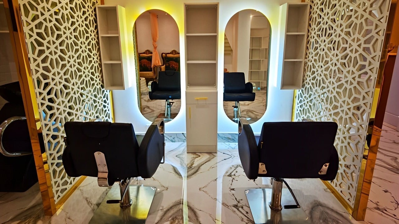 Salon area with lattice screens, gold-framed mirrors and marble counters
