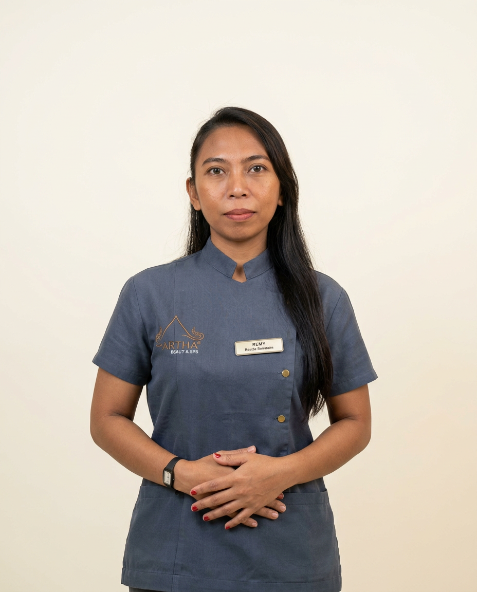 Imas, beauty therapist, in a grey Thai House uniform on a cream background